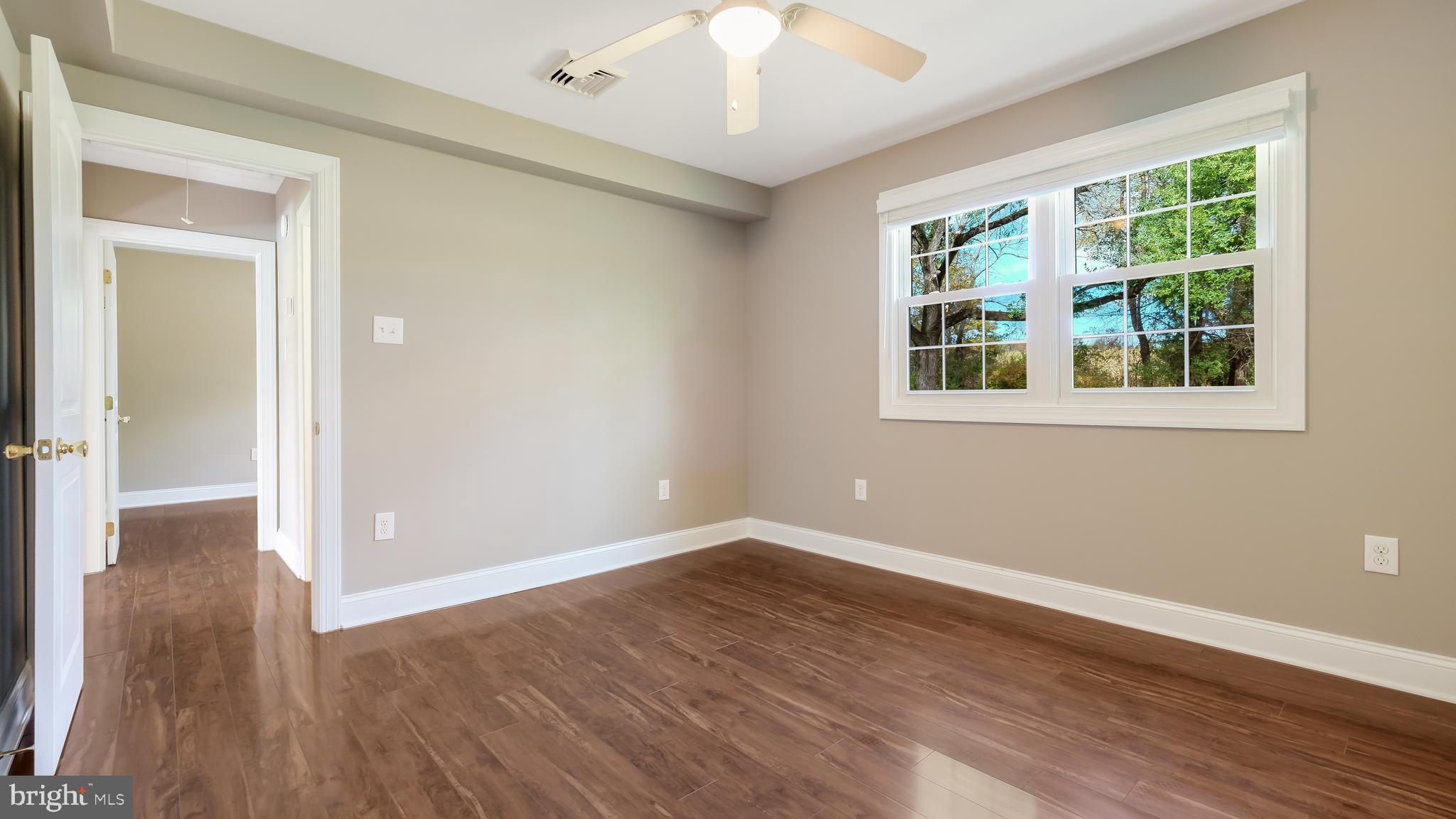 1732 Creek Road New Hope, PA 18938 - Photo 22 of 42 a view of an empty room with wooden floor and a window