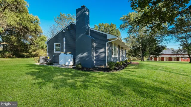 a view of a house with a yard and sitting area