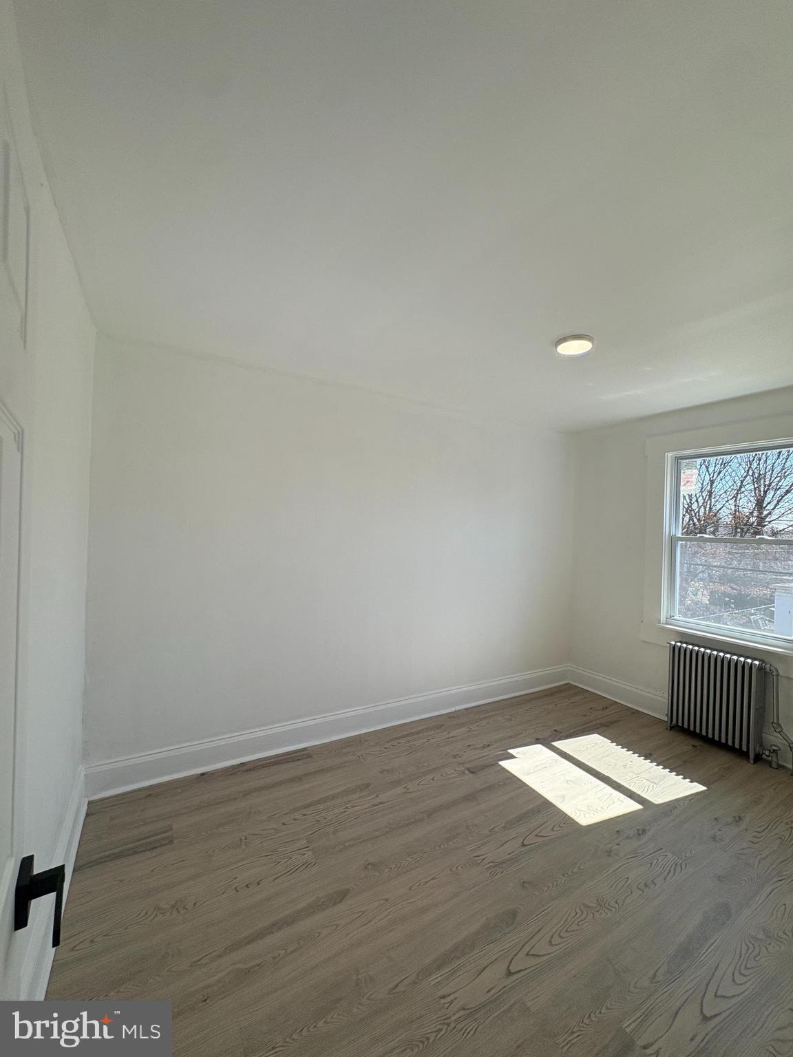 2892 North Constitution Road Camden, NJ 08104 - Photo 11 of 17 an empty room with wooden floor and windows