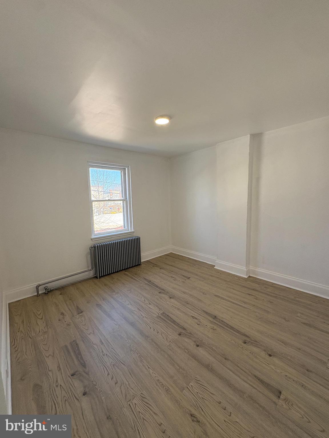 2892 North Constitution Road Camden, NJ 08104 - Photo 12 of 17 an empty room with wooden floor and windows
