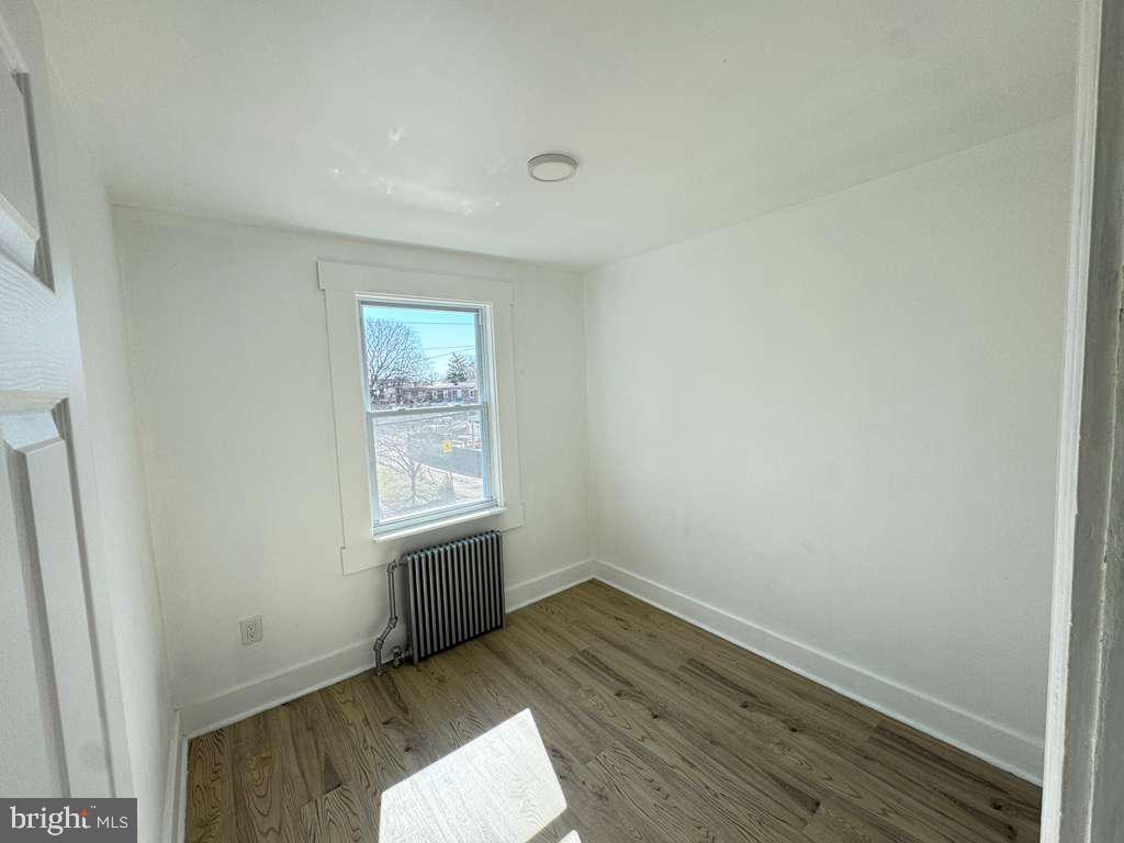 2892 North Constitution Road Camden, NJ 08104 - Photo 13 of 17 an empty room with wooden floor and windows