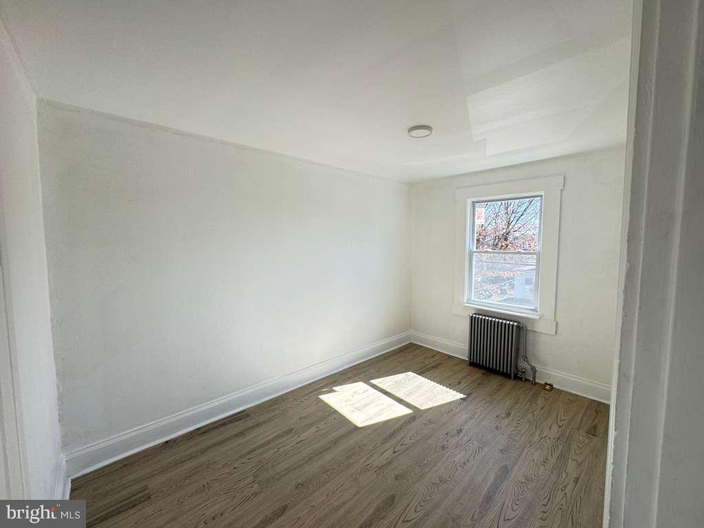 2892 North Constitution Road Camden, NJ 08104 - Photo 14 of 17 an empty room with wooden floor and windows