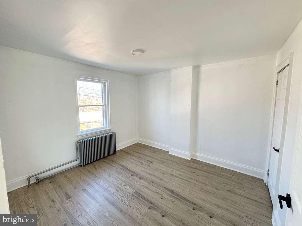 2892 North Constitution Road Camden, NJ 08104 - Photo 15 of 17 an empty room with wooden floor and windows