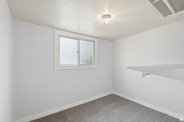 215 East 300 South Logan, UT 84321 - Photo 15 of 32 Unfurnished room with carpet floors and a textured ceiling