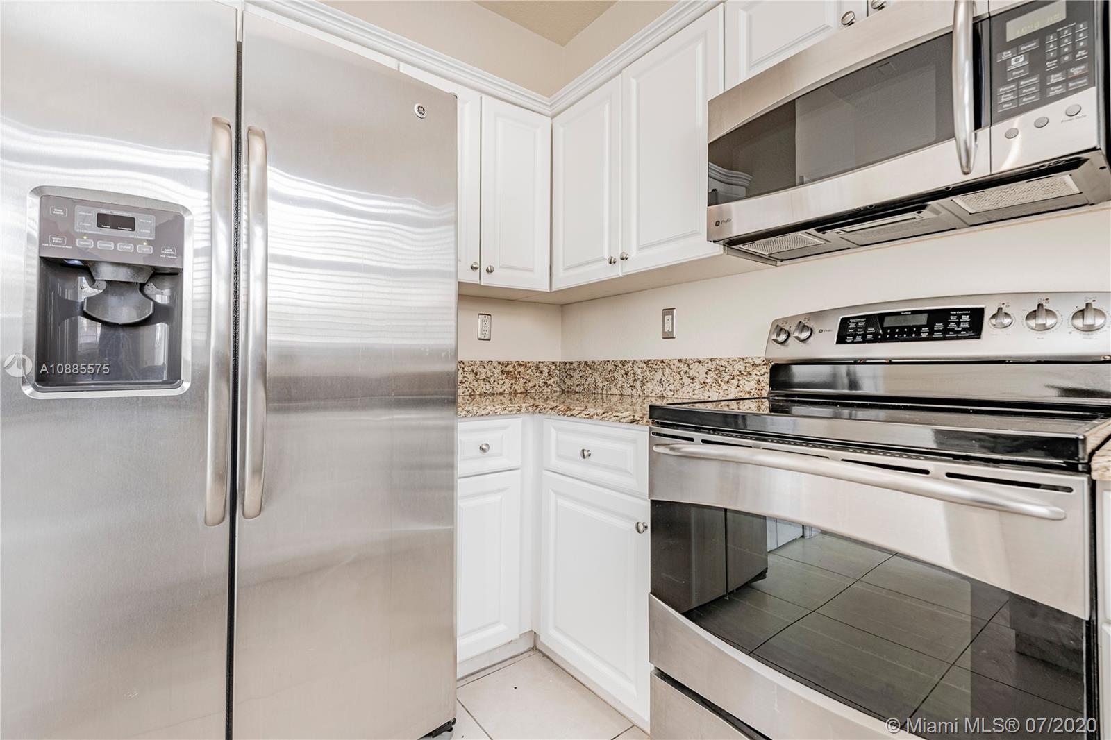 11926 Southwest 152nd Place Miami, FL 33196 - Photo 18 of 48 a kitchen with stainless steel appliances granite countertop a refrigerator and a stove