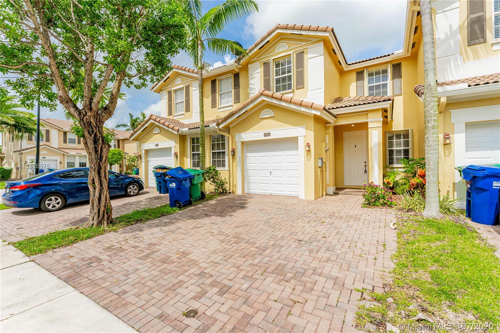 11926 Southwest 152nd Place Miami, FL 33196 - Photo 2 of 48 a front view of a house with a yard and garage
