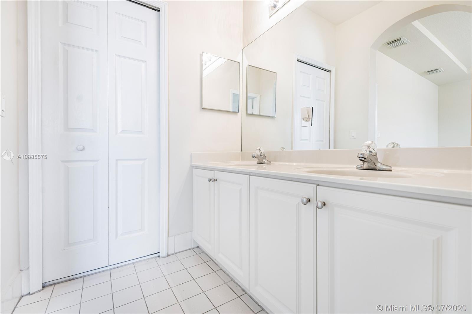 11926 Southwest 152nd Place Miami, FL 33196 - Photo 29 of 48 a bathroom with a sink and a mirror