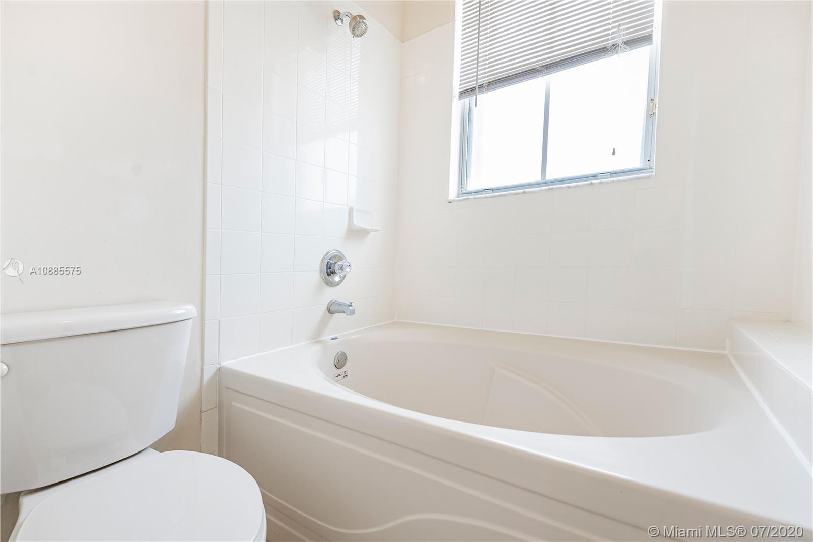11926 Southwest 152nd Place Miami, FL 33196 - Photo 30 of 48 a white bath tub sitting next to a white toilet