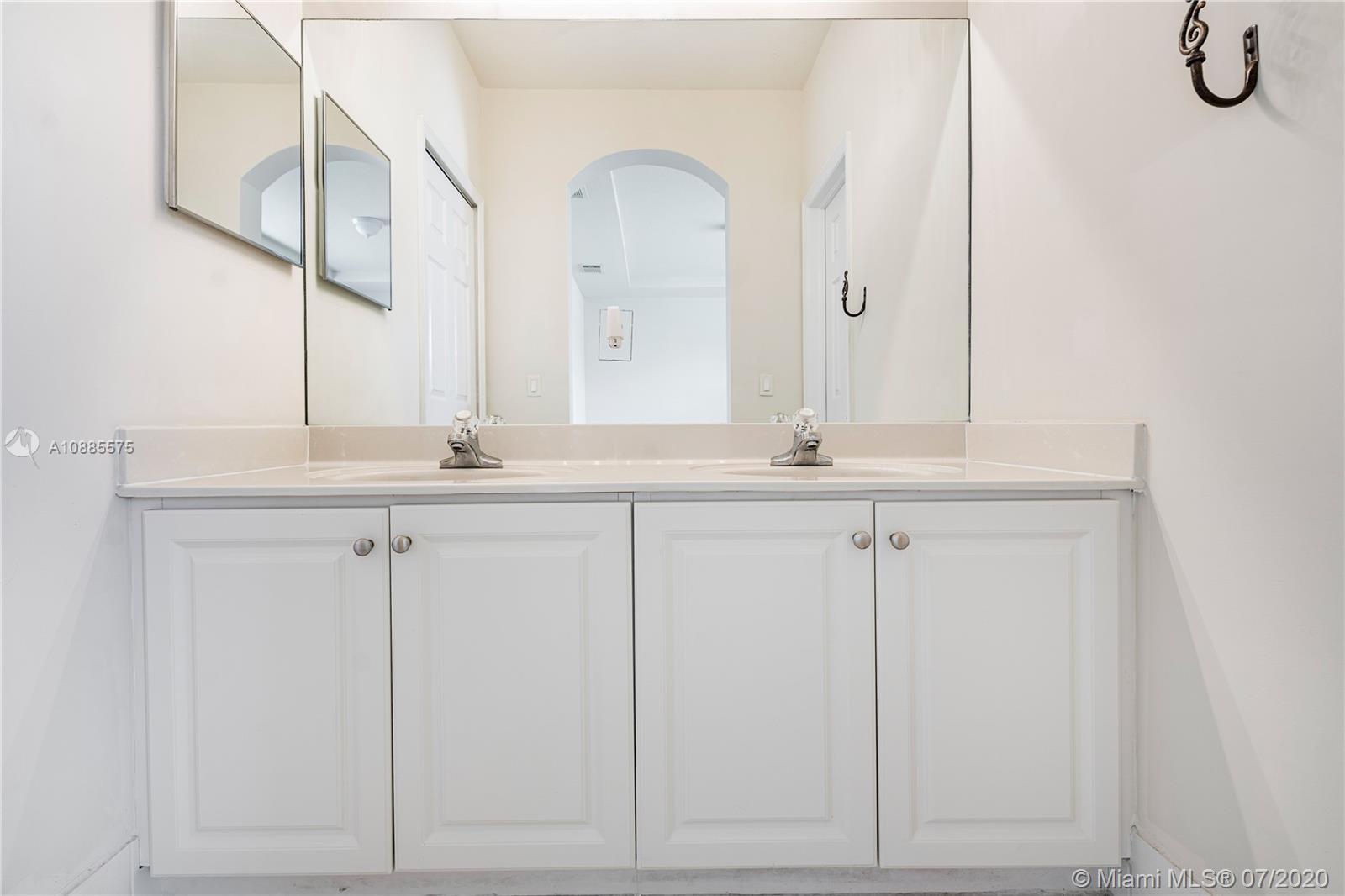 11926 Southwest 152nd Place Miami, FL 33196 - Photo 31 of 48 a bathroom with a sink and vanity