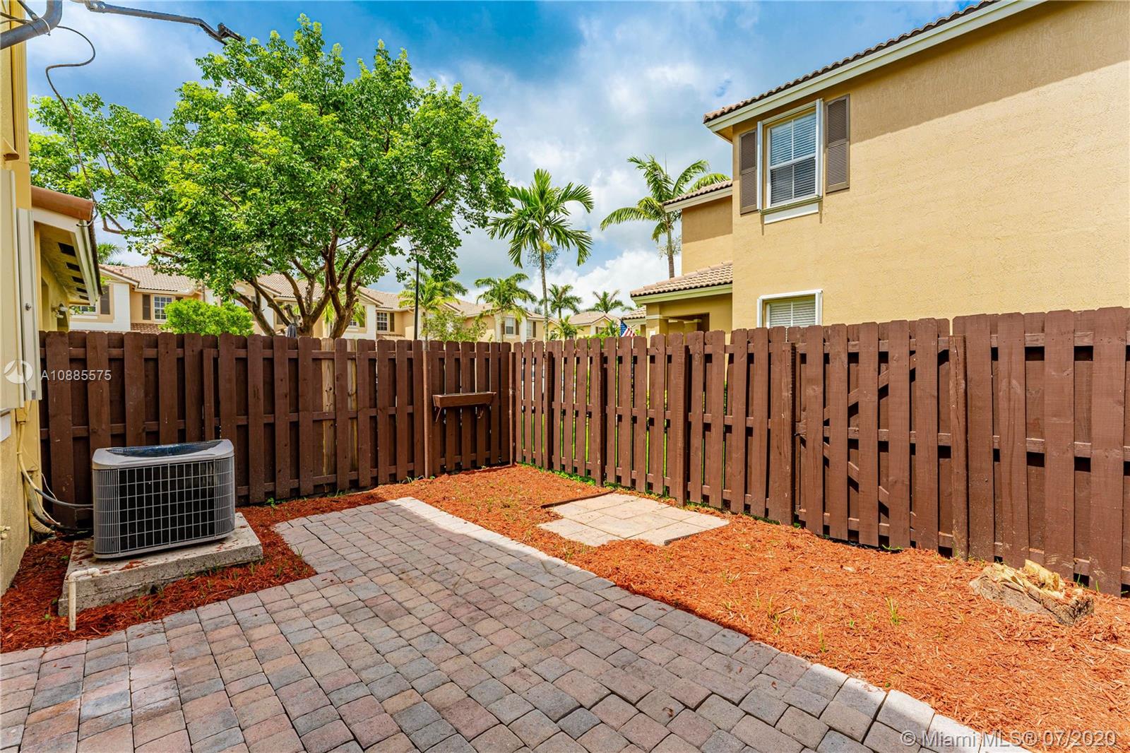 11926 Southwest 152nd Place Miami, FL 33196 - Photo 34 of 48 a backyard of a house with wooden fence