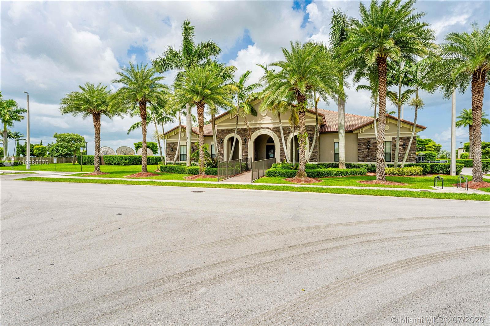 11926 Southwest 152nd Place Miami, FL 33196 - Photo 38 of 48 a front view of a house with a garden and trees