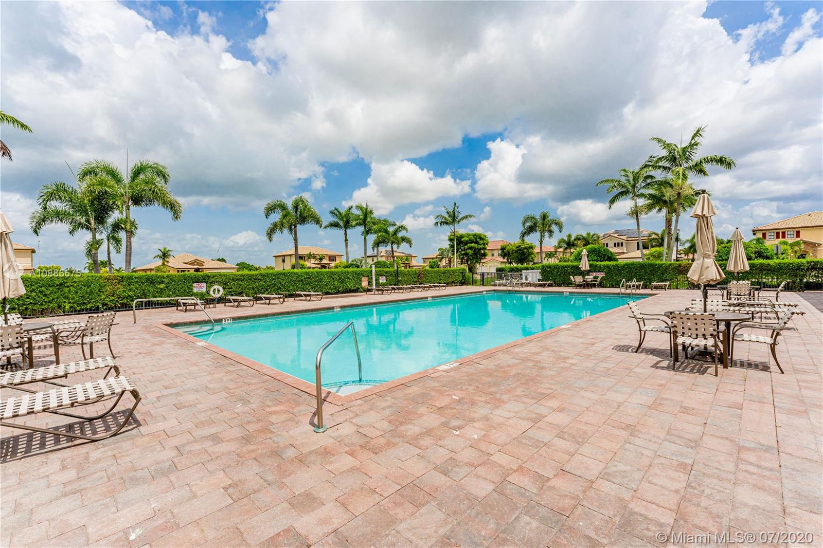 11926 Southwest 152nd Place Miami, FL 33196 - Photo 42 of 48 a view of a swimming pool and lounge chairs