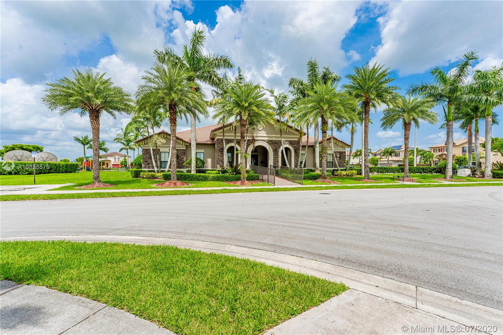 11926 Southwest 152nd Place Miami, FL 33196 - Photo 43 of 48 a front view of multi story residential apartment building with yard and green space
