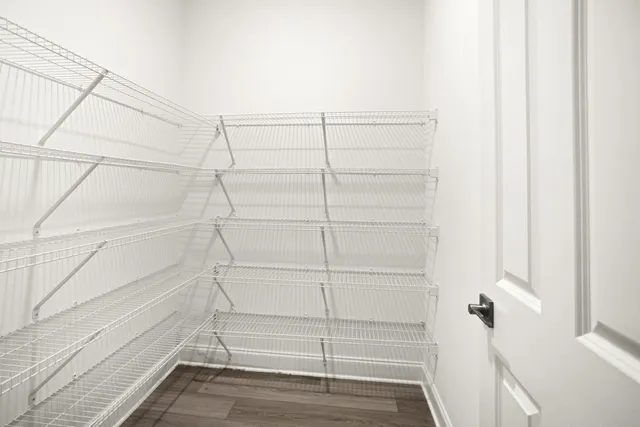 a kitchen with a sink stainless steel appliances and white cabinets