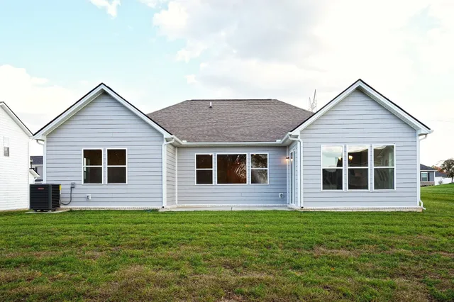 a view of a house with a backyard