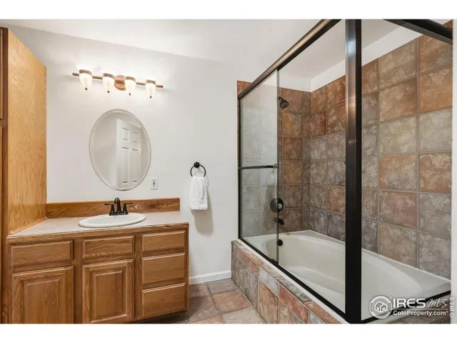 an empty room with a ceiling fan and window