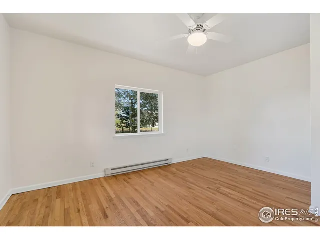 a view of an empty room and a ceiling fan