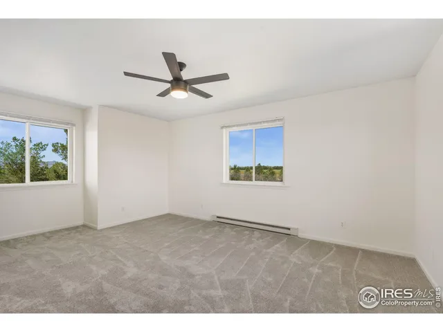 a view of a ceiling fan and closet in a room