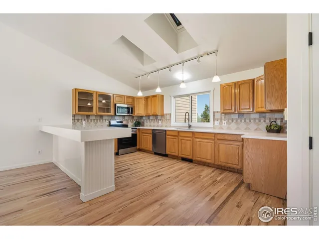 a kitchen with a sink cabinets and wooden floor
