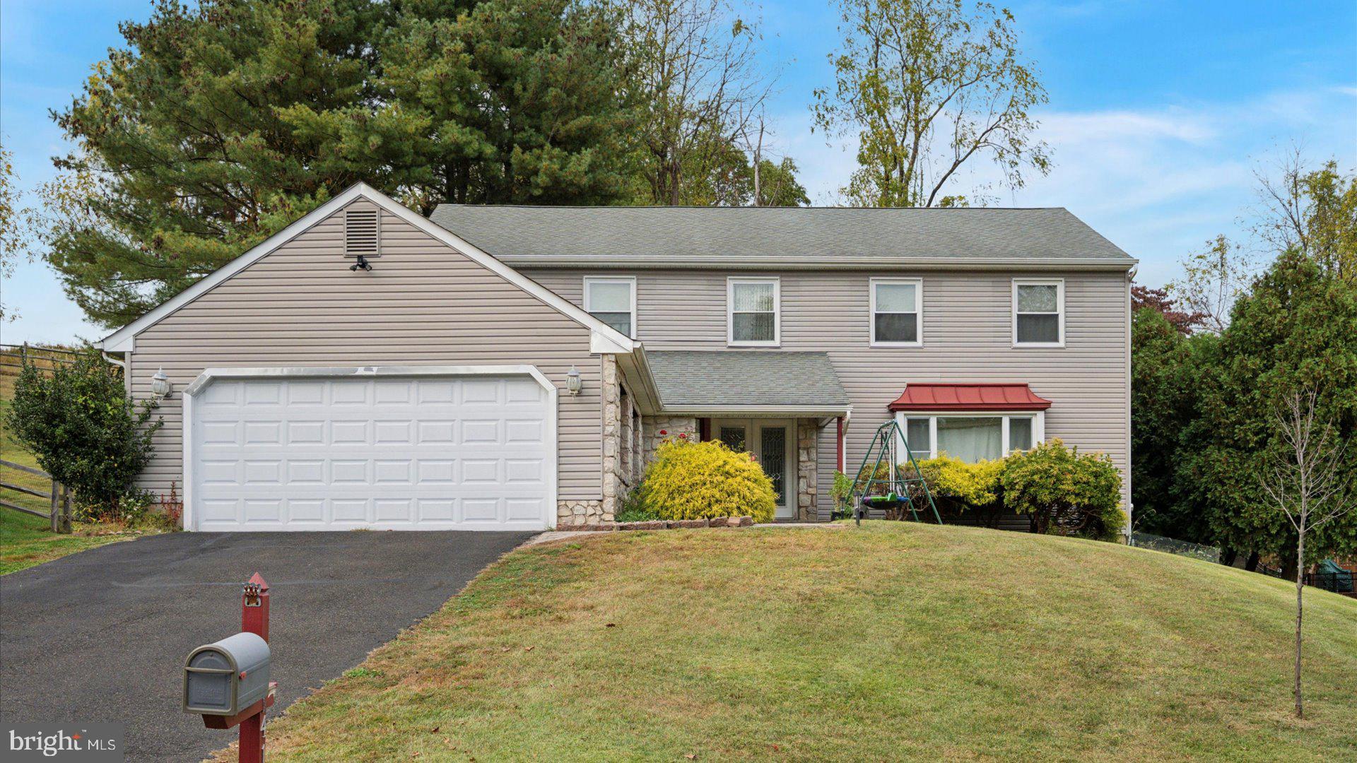 415 Fox Hollow Drive Feasterville-Trevose, PA 19053 - Photo 1 of 26 a front view of a house with a yard and garage