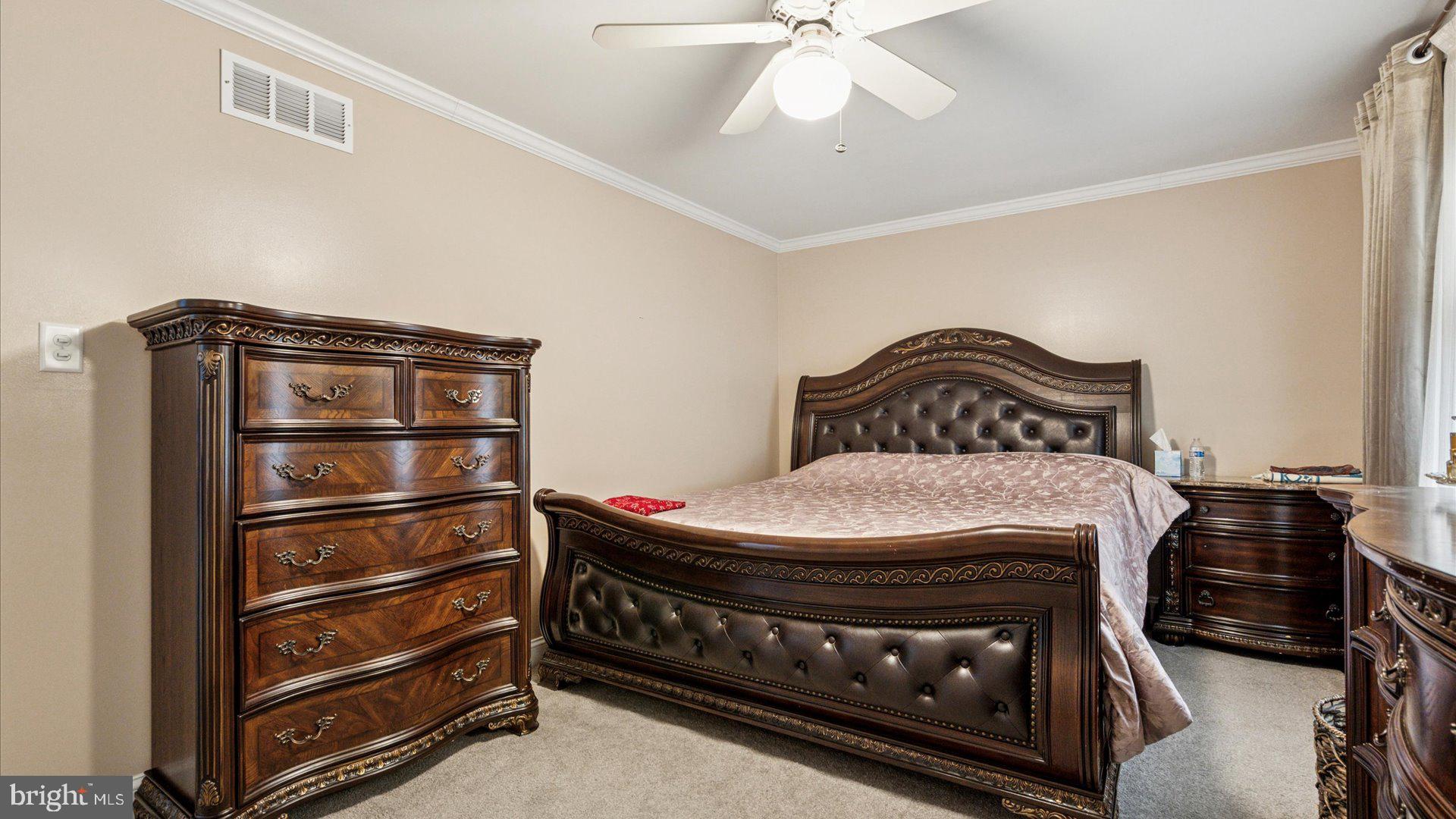 415 Fox Hollow Drive Feasterville-Trevose, PA 19053 - Photo 14 of 26 a bedroom with a bed and a chandelier