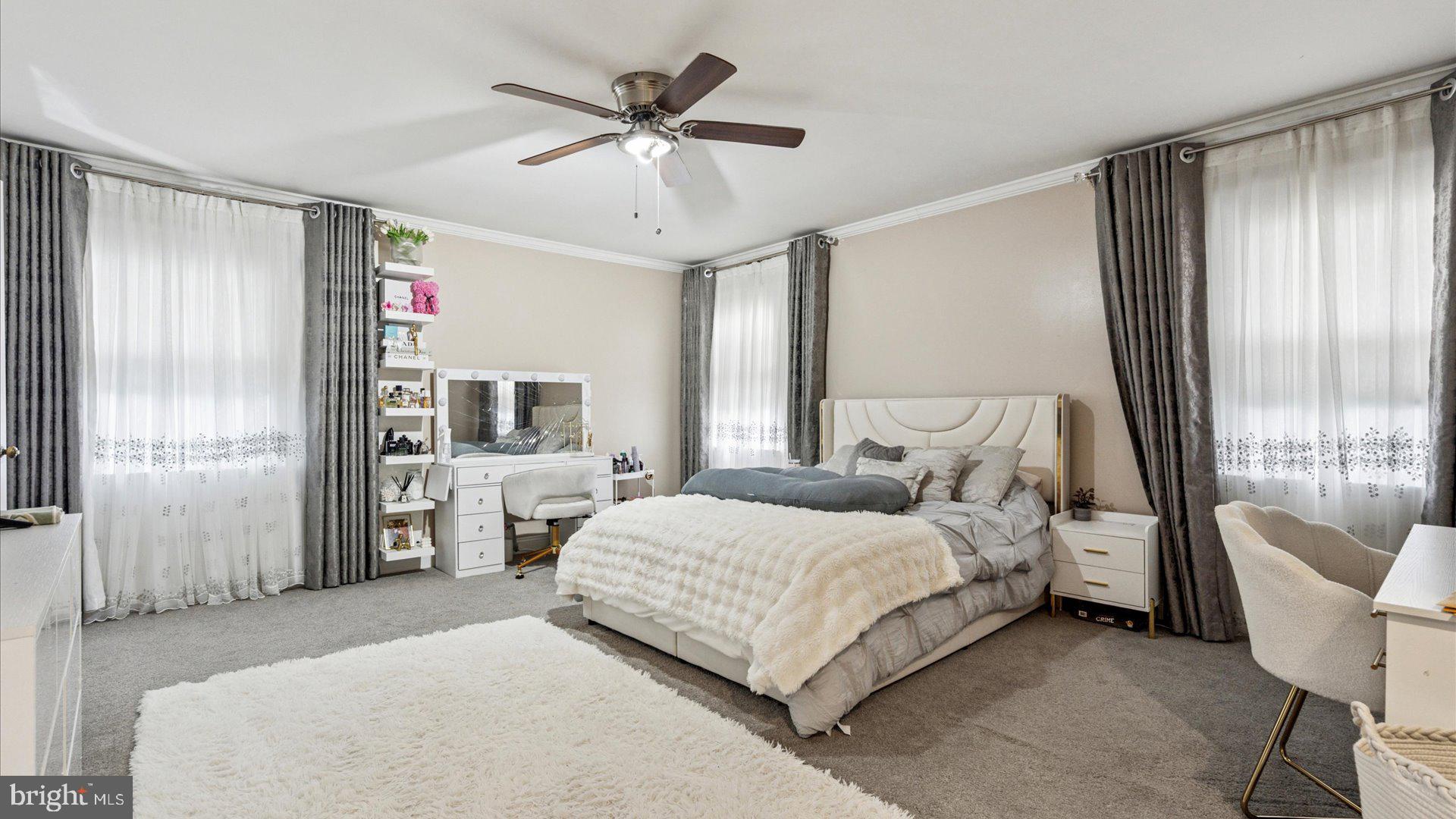 415 Fox Hollow Drive Feasterville-Trevose, PA 19053 - Photo 16 of 26 a bedroom with a large bed a chandelier and dresser