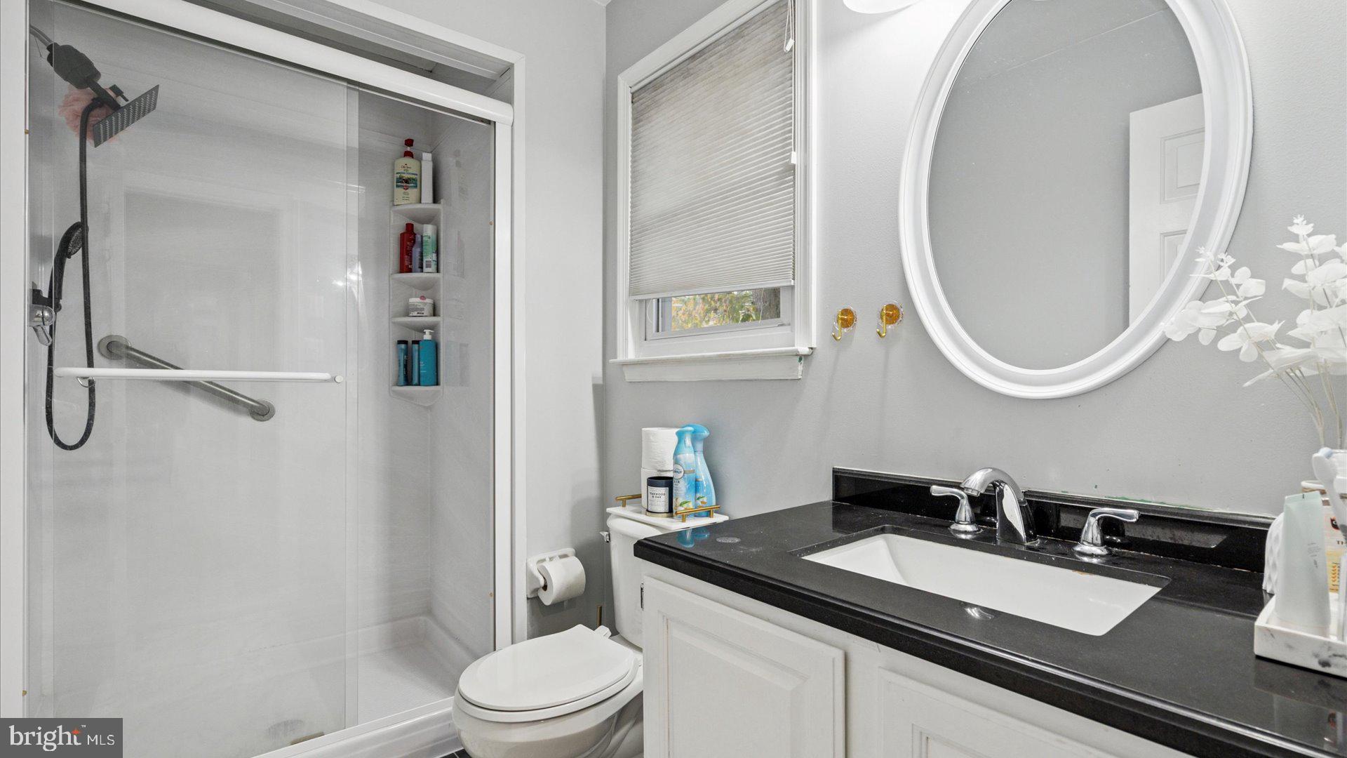 415 Fox Hollow Drive Feasterville-Trevose, PA 19053 - Photo 17 of 26 a bathroom with a granite countertop sink toilet a mirror and shower