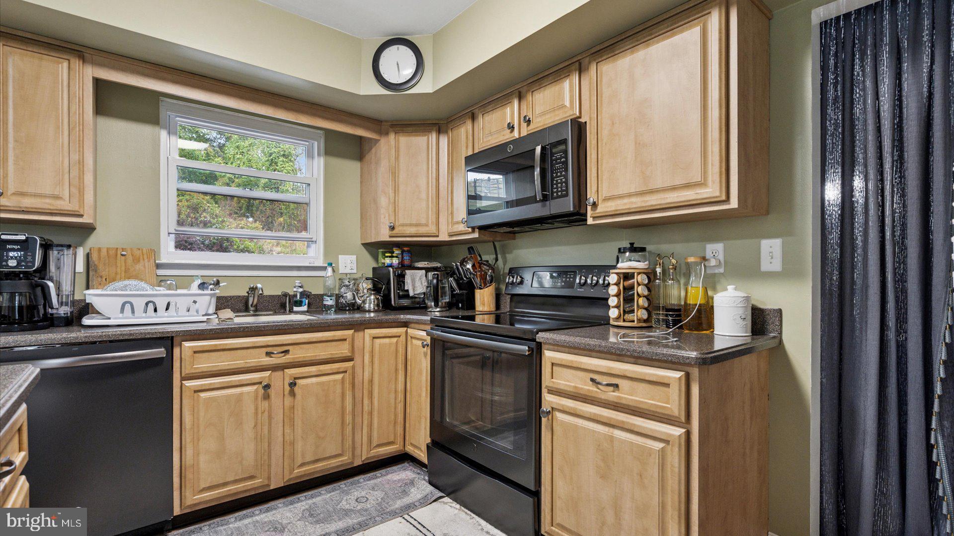 415 Fox Hollow Drive Feasterville-Trevose, PA 19053 - Photo 6 of 26 a kitchen with stainless steel appliances granite countertop white cabinets sink and a window
