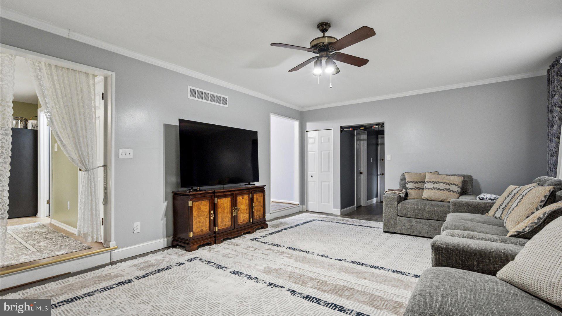 415 Fox Hollow Drive Feasterville-Trevose, PA 19053 - Photo 9 of 26 a living room with furniture and a flat screen tv