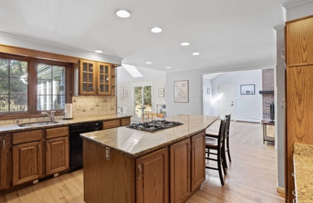 4 Kitson Park Drive Lexington, MA 02421 - Photo 11 of 38 a kitchen with granite countertop a sink and cabinets
