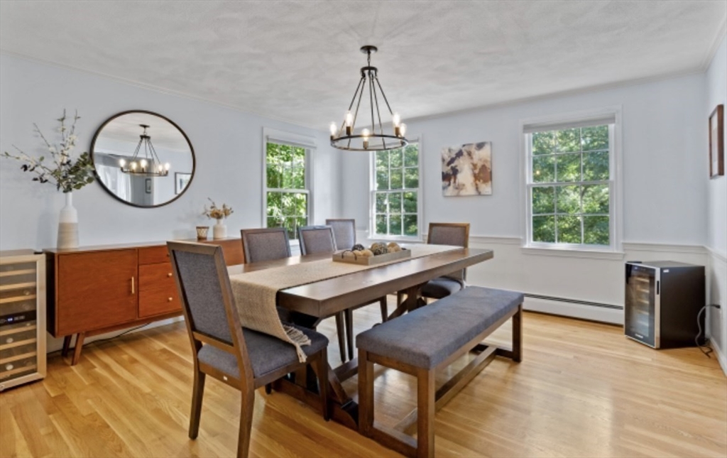 4 Kitson Park Drive Lexington, MA 02421 - Photo 17 of 38 a dining room with wooden floor a chandelier a wooden table and chairs