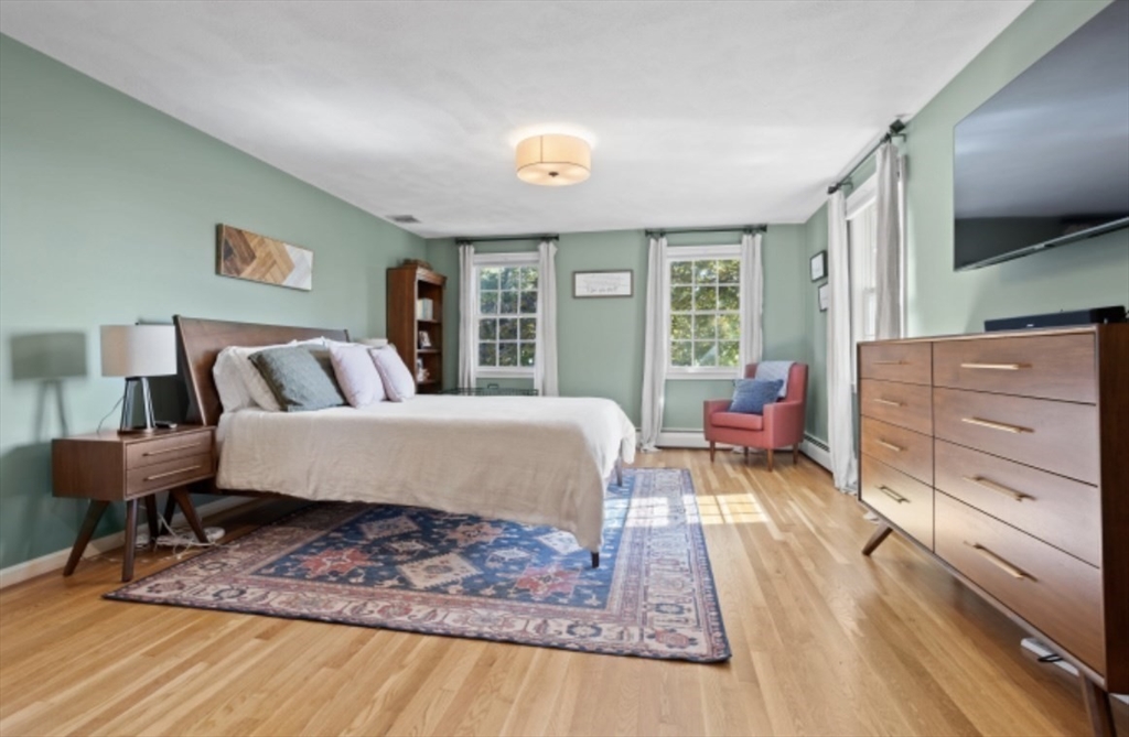 4 Kitson Park Drive Lexington, MA 02421 - Photo 24 of 38 a bedroom with a bed and wooden floor