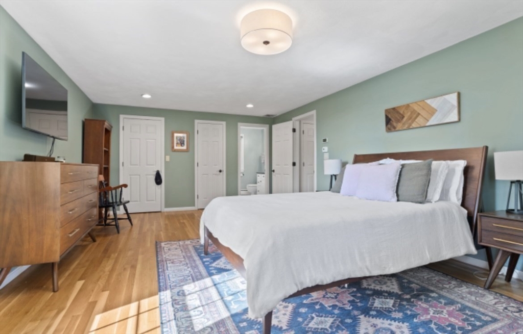 4 Kitson Park Drive Lexington, MA 02421 - Photo 25 of 38 a spacious bedroom with a bed and a flat screen tv