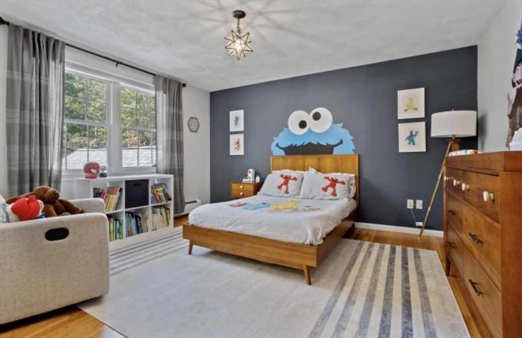 4 Kitson Park Drive Lexington, MA 02421 - Photo 26 of 38 a bedroom with a bed and wooden floor