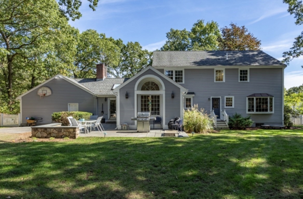 4 Kitson Park Drive Lexington, MA 02421 - Photo 3 of 38 a front view of a house with a garden and yard