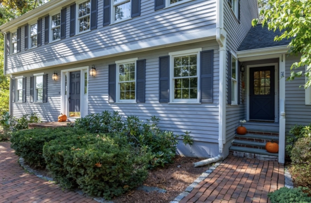 4 Kitson Park Drive Lexington, MA 02421 - Photo 33 of 38 a view of brick house with potted plants and a table and chairs