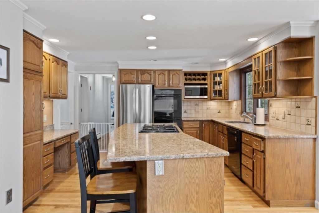 4 Kitson Park Drive Lexington, MA 02421 - Photo 7 of 38 a kitchen with a table chairs sink and cabinets