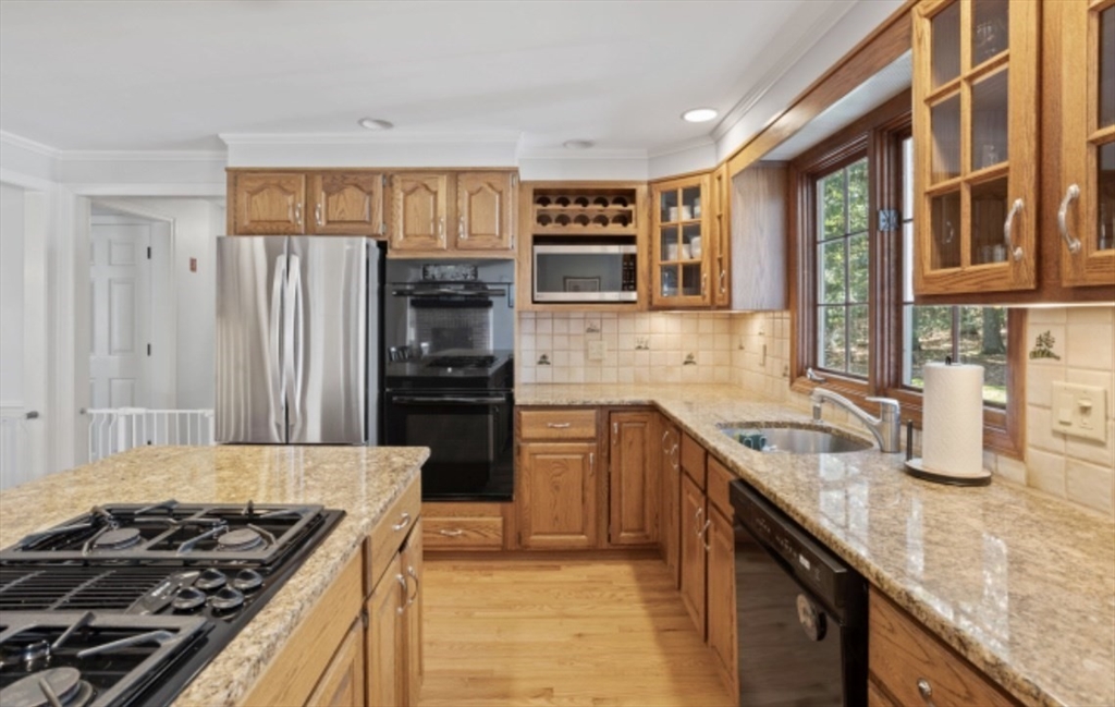 4 Kitson Park Drive Lexington, MA 02421 - Photo 8 of 38 a kitchen with stainless steel appliances granite countertop a stove and a sink