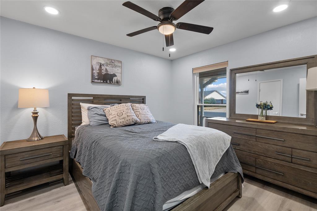 7629 Cedarhill Road Watauga, TX 76148 - Photo 16 of 26 Recessed lighting, wood-finish flooring, ceiling fan with light fixture, and window with a roller shade
