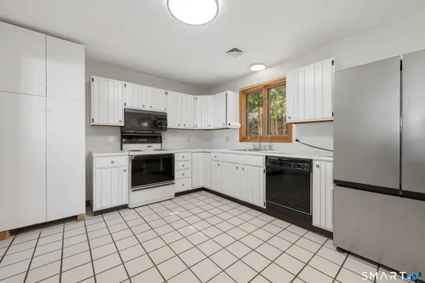a kitchen with a stove a sink and a microwave