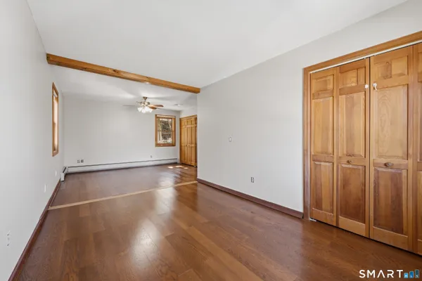 an empty room with wooden floor and closet