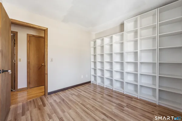 a view of a room with wooden floor and closet