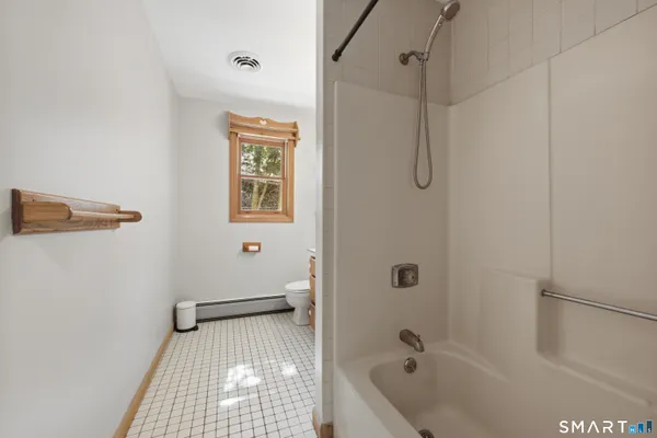 a bathroom with a tub a sink and a shower
