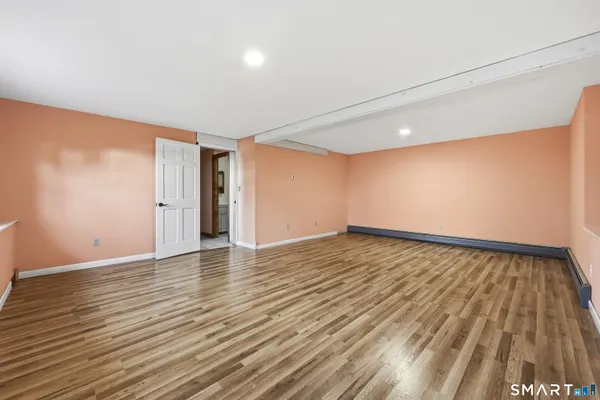 a view of an empty room and wooden floor