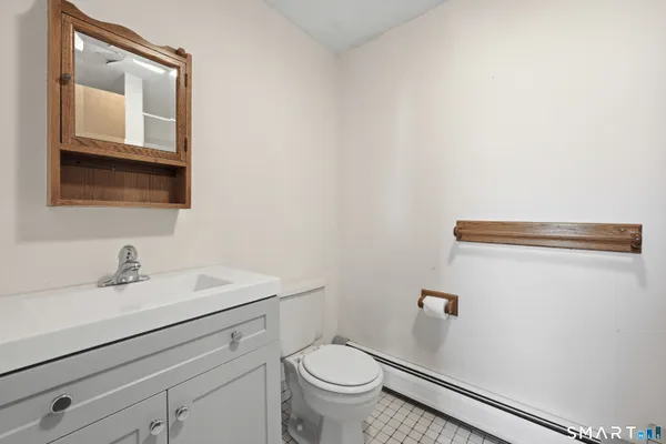 a bathroom with a sink a toilet and mirror