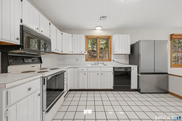 a kitchen with a sink a stove and refrigerator