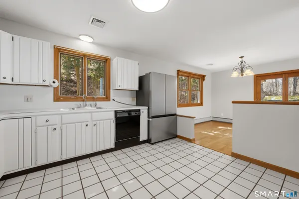 a kitchen with stainless steel appliances a refrigerator sink and cabinets