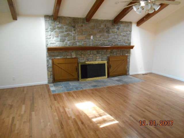 600 Murfreesboro Street Murfreesboro, TN 37127 - Photo 7 of 27 a room with a fireplace and a wooden floor
