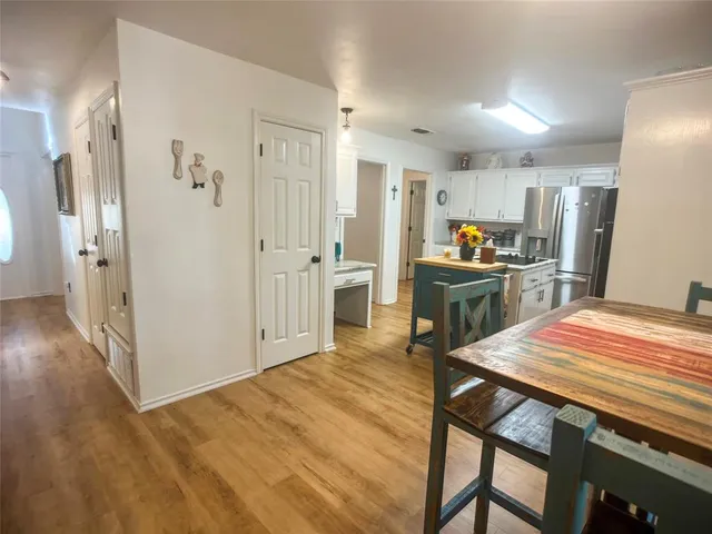 a kitchen with stainless steel appliances a refrigerator and a stove top oven