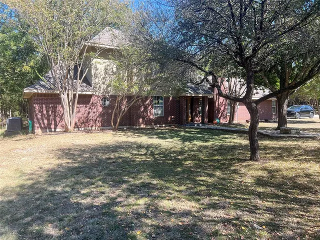 a view of swimming pool with outdoor seating and house in the background